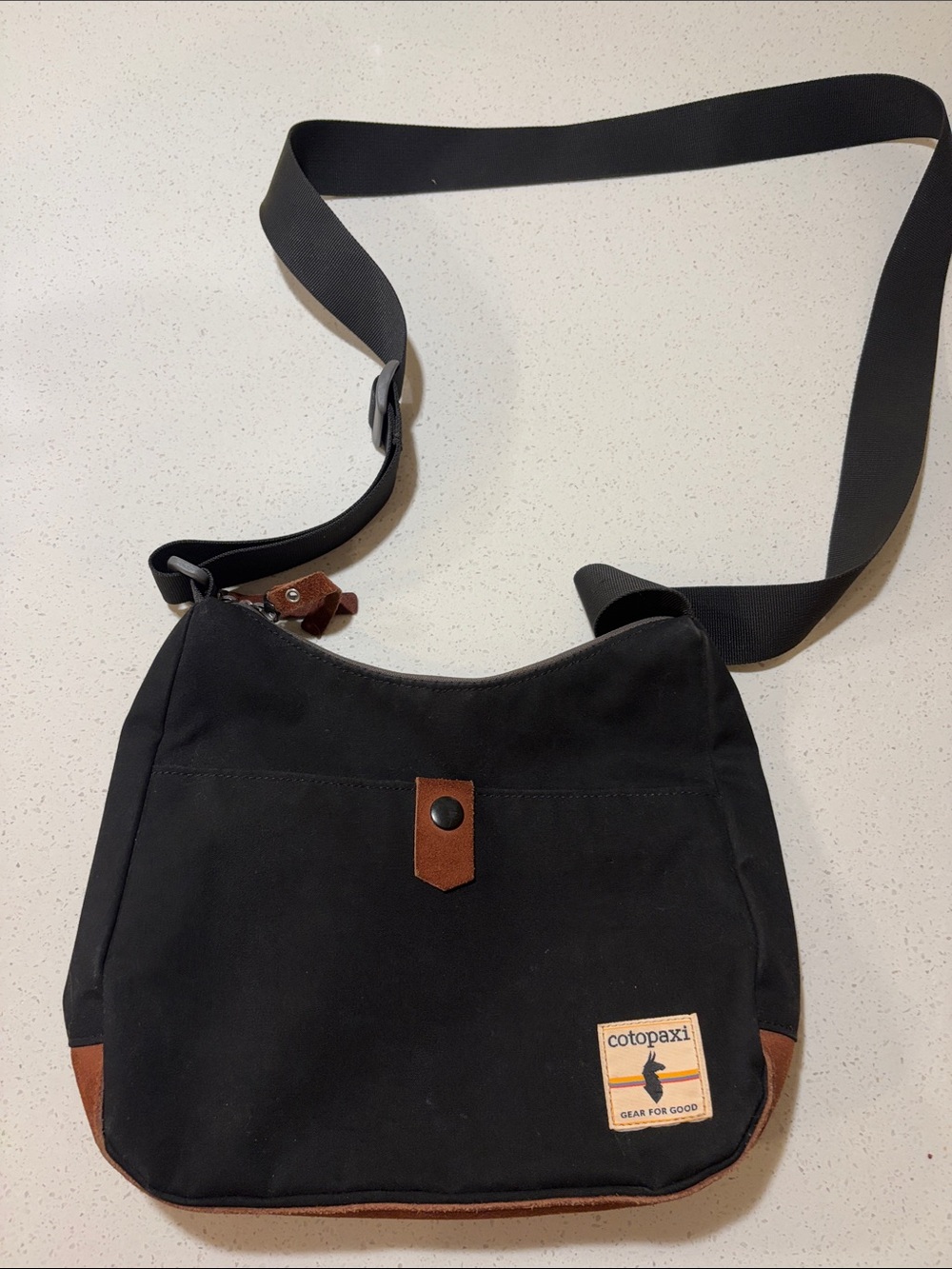 cotopaxi Black Canvas Messenger Bag with Brown Leather Trim